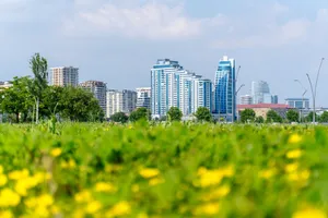 Vibrant view of Baku's modern skyline with lush greenery and yellow flowers in the foreground. Perfect urban nature contrast. jigsaw puzzle