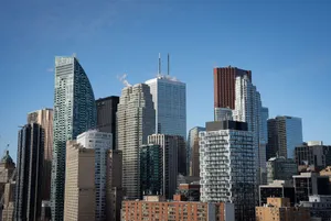 Aerial view of Toronto's iconic skyline featuring modern skyscrapers under a clear blue sky. jigsaw puzzle