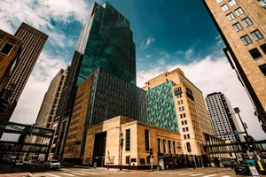 A dramatic view of modern skyscrapers in downtown Minneapolis under a vivid blue sky. jigsaw puzzle