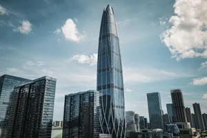 Striking modern skyscraper amidst an urban cityscape under a clear sky. jigsaw puzzle