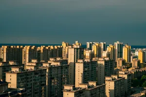 Bright cityscape view of modern high-rise apartments with a clear sky backdrop. jigsaw puzzle