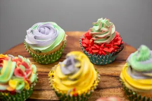Vibrant cupcakes with decorative buttercream frosting on a wooden tray, perfect for celebrations. jigsaw puzzle