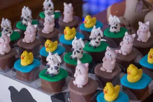 Colorful cupcakes with cute farm animal toppers, perfect for kids' events and themed celebrations. jigsaw puzzle