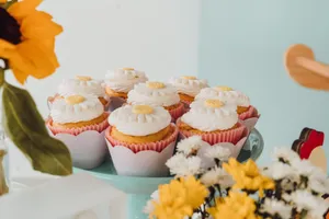 Cupcakes with flower designs on a stand surrounded by spring flowers. jigsaw puzzle