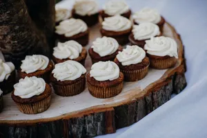 Wooden platter showcasing chocolate cupcakes with vanilla frosting, perfect for dessert lovers. jigsaw puzzle