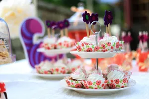 An elegant display of cupcakes with floral liners, perfect for a festive outdoor celebration. jigsaw puzzle
