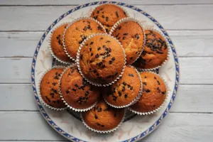 Top view of chocolate chip muffins arranged on a decorative plate. jigsaw puzzle