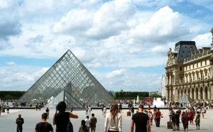 Crowded view of the iconic Louvre Pyramid with tourists in Paris, France on a sunny day. jigsaw puzzle