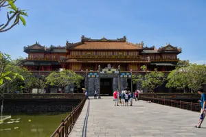 Tourists exploring the historic Imperial City in Hue, Vietnam under a clear blue sky. jigsaw puzzle