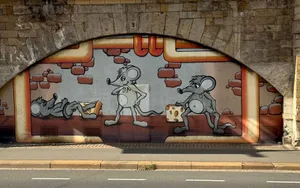 Colorful mural of cartoon mice with cheese on a wall under an arch in Germany. jigsaw puzzle