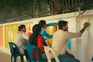A group of artists collaboratively painting a colorful mural on a wall in Dhaka. jigsaw puzzle