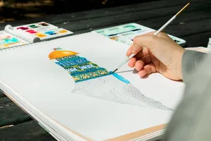 Close-up of a hand painting the Dome of the Rock in watercolor outdoors. jigsaw puzzle
