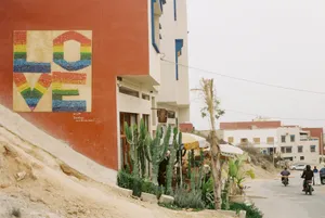 A vibrant mural reading 'LOVE' in a Moroccan street with cactus and buildings, capturing local culture. jigsaw puzzle