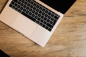 Overhead view of a laptop computer on a wooden table, perfect for tech-related themes. jigsaw puzzle