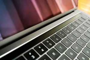Detailed close-up of a sleek, modern laptop keyboard with a reflective screen, emphasizing technology and design. jigsaw puzzle
