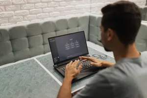 A man working on a laptop in a cozy, modern office space with a focus on technology. jigsaw puzzle