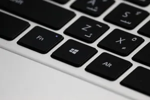 Detailed view of a laptop keyboard featuring Arabic letters and Windows key. jigsaw puzzle