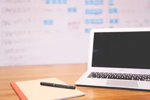 Clean and organized workspace with a laptop, notepad, and pen for planning and projects. jigsaw puzzle