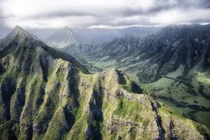 Breathtaking aerial view of rugged mountains and valleys under dramatic clouds. jigsaw puzzle