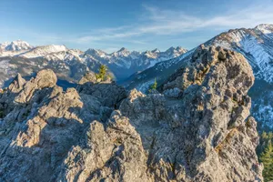 A breathtaking view of the snow-capped peaks in the Tatras Mountains under a clear blue sky. jigsaw puzzle