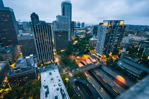 Explore Seattle's dynamic skyline and bustling streets from above, illuminated at twilight. jigsaw puzzle