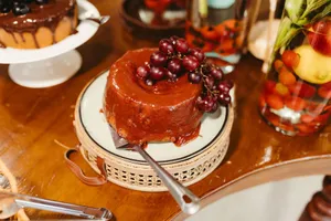 Mouthwatering cake topped with grapes, perfect for dessert lovers. jigsaw puzzle