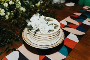 Beautiful white floral cake on a colorful table setting, perfect for celebrations. jigsaw puzzle