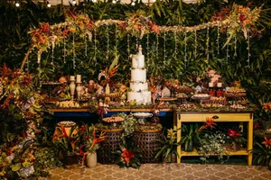 Luxurious wedding cake table surrounded by vibrant floral and green foliage decor, perfect for celebrations. jigsaw puzzle
