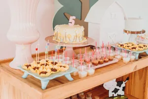 Brightly decorated dessert table with a birthday cake and treats, perfect for a celebration. jigsaw puzzle