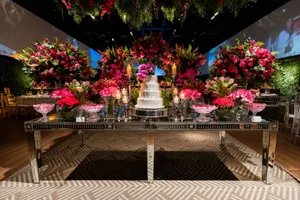 Luxurious wedding reception setup with floral decor and a tiered cake centerpiece. jigsaw puzzle