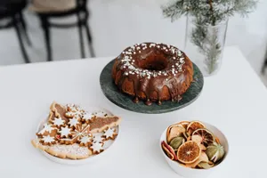A delicious chocolate drizzled bundt cake with festive gingerbread cookies and dried citrus slices. jigsaw puzzle