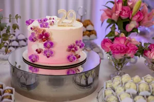 A beautifully decorated birthday cake with orchids and floral arrangements for a 29th celebration. jigsaw puzzle