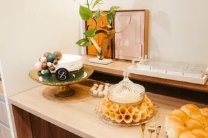 A stylish buffet with an elegant cake, pastries, and decor in an upscale setting. jigsaw puzzle