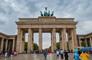 The iconic Brandenburg Gate in Berlin, Germany with people and umbrellas on a rainy day jigsaw puzzle