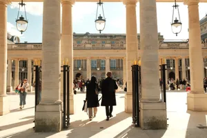 A bustling courtyard in Paris, featuring architectural columns and people enjoying the day. jigsaw puzzle