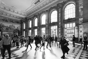 Historic São Bento Railway Station interior with people walking past the large windows. jigsaw puzzle