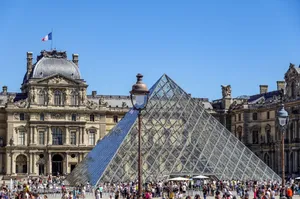 Iconic Louvre Pyramid with bustling crowds in Paris, France on a sunny day. jigsaw puzzle
