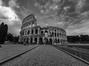 Black and white of historic Colosseum with tourists walking on paved square in Madrid jigsaw puzzle
