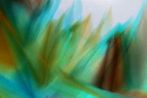 A dynamic abstract image featuring vibrant waves of blue, green, and brown light, creating a sense of motion. jigsaw puzzle