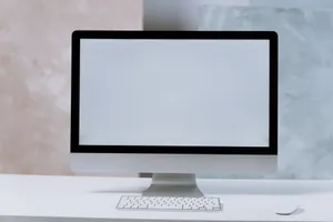 A sleek iMac desktop computer on a minimalist white desk with a keyboard and mouse. jigsaw puzzle