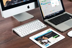 A sleek office desk setup featuring Apple devices: iMac, MacBook, and iPad. jigsaw puzzle