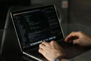 Close-up of hands coding on a laptop, focusing on programming productivity. jigsaw puzzle