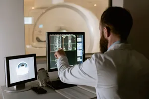 Medical professional reviewing MRI scans on computer screens for diagnostic purposes. jigsaw puzzle