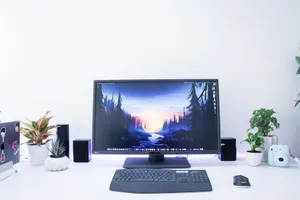 Contemporary desk setup featuring a monitor, plants, and electronic devices in a sleek, minimalist design. jigsaw puzzle