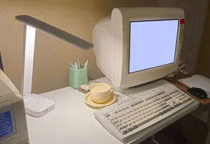 A nostalgic home office featuring a vintage computer, keyboard, and coffee cup. jigsaw puzzle
