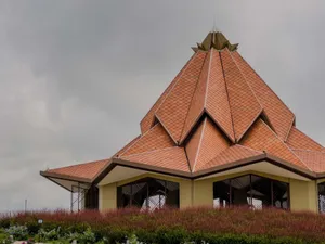 Striking geometric architecture with tiled roof under an overcast sky, capturing intricate design elements. jigsaw puzzle