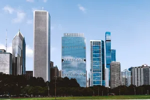 Scenery of modern glass skyscrapers of Chicago city surrounded with lush green park under blue sky jigsaw puzzle