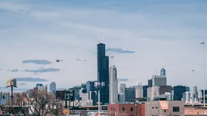 Wide view of Chicago's urban skyline featuring Willis Tower under a clear sky. jigsaw puzzle