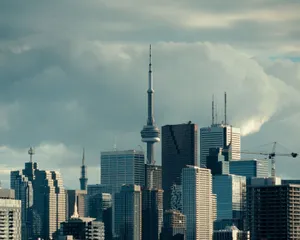 Stunning view of Toronto's skyline featuring the iconic CN Tower under cloudy skies. jigsaw puzzle