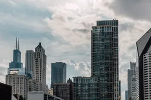 A vibrant urban skyline showcasing modern skyscrapers against a cloudy sky. jigsaw puzzle